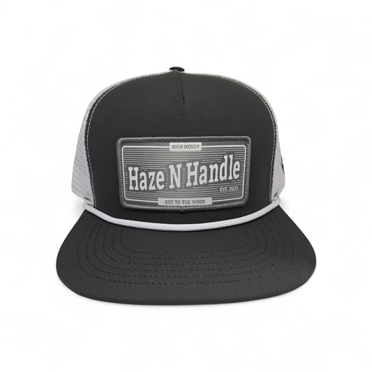Haze N Handle black and gray trucker cap with rope detail and woven patch. Adjustable back.