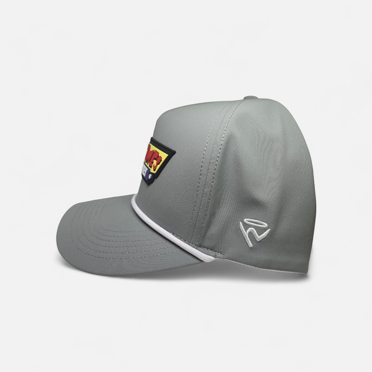 Haze N Handle stone-gray structured baseball cap with white rope detail and a bold red, yellow, and blue embroidered patch.