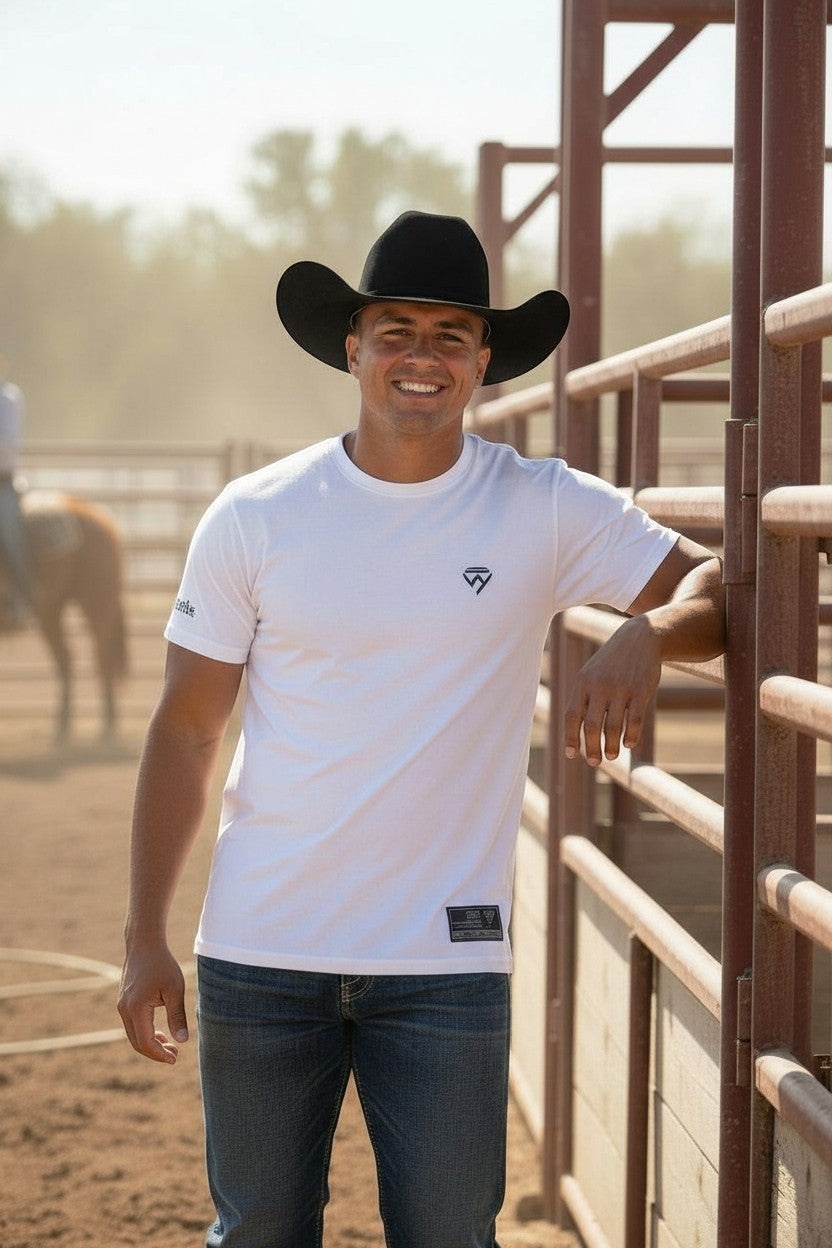 Haze N Handle white cotton t-shirt with a small black logo on the chest, worn by a man in jeans and a cowboy hat.
