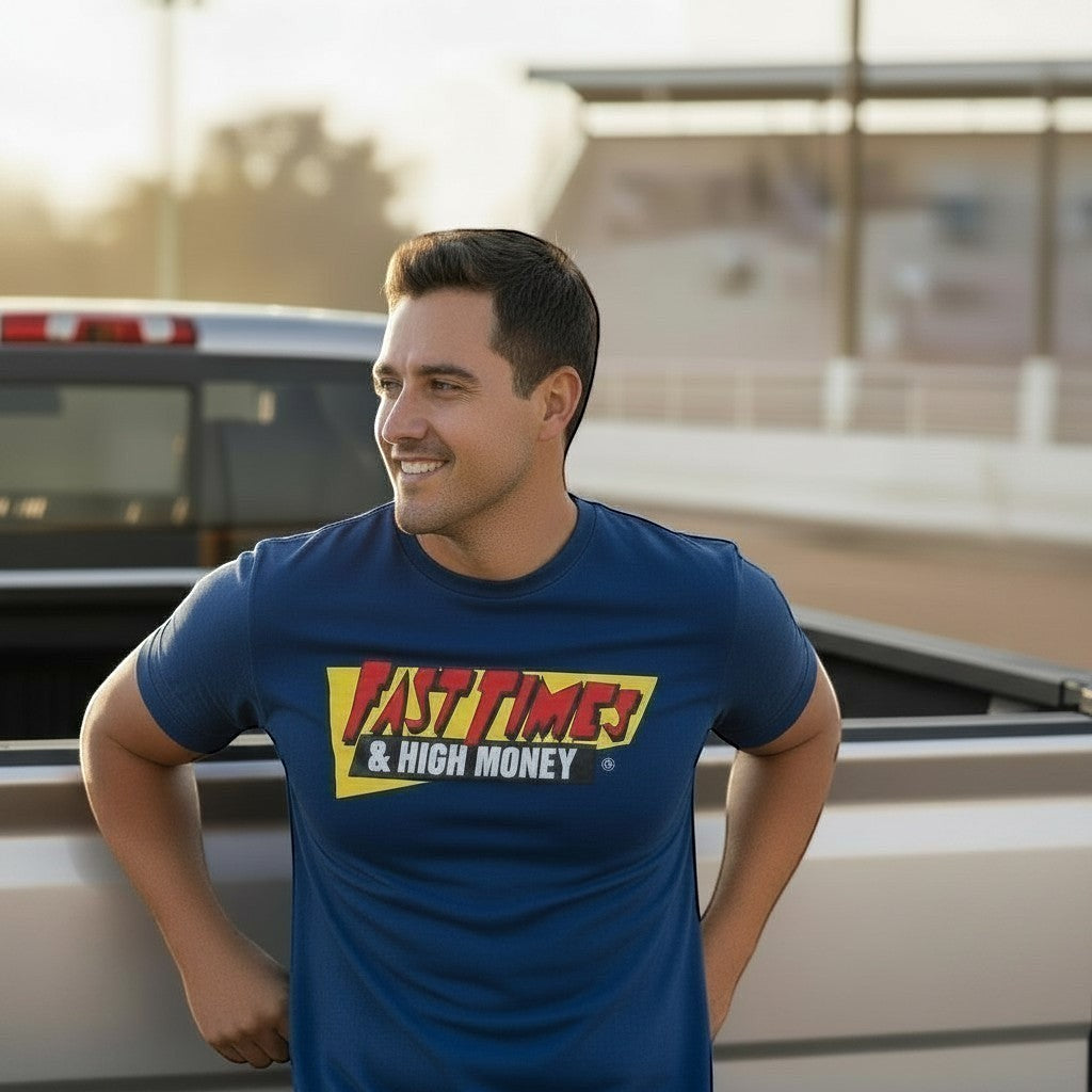 Haze N Handle navy blue cotton t-shirt with bold yellow and red "Fast Times & High Money" graphic on chest. Model leans against a truck.