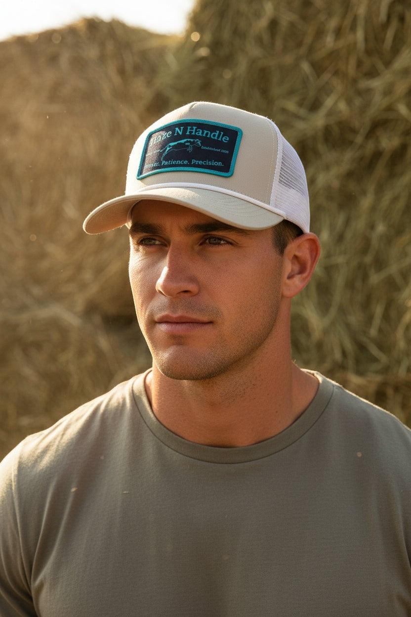 Haze N Handle stone trucker hat with white mesh back, rope detail, and teal and black embroidered patch.